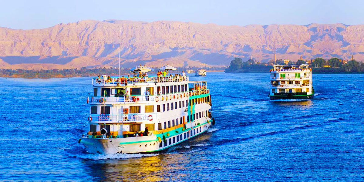 A traditional felucca sailboat on the Nile River at sunset